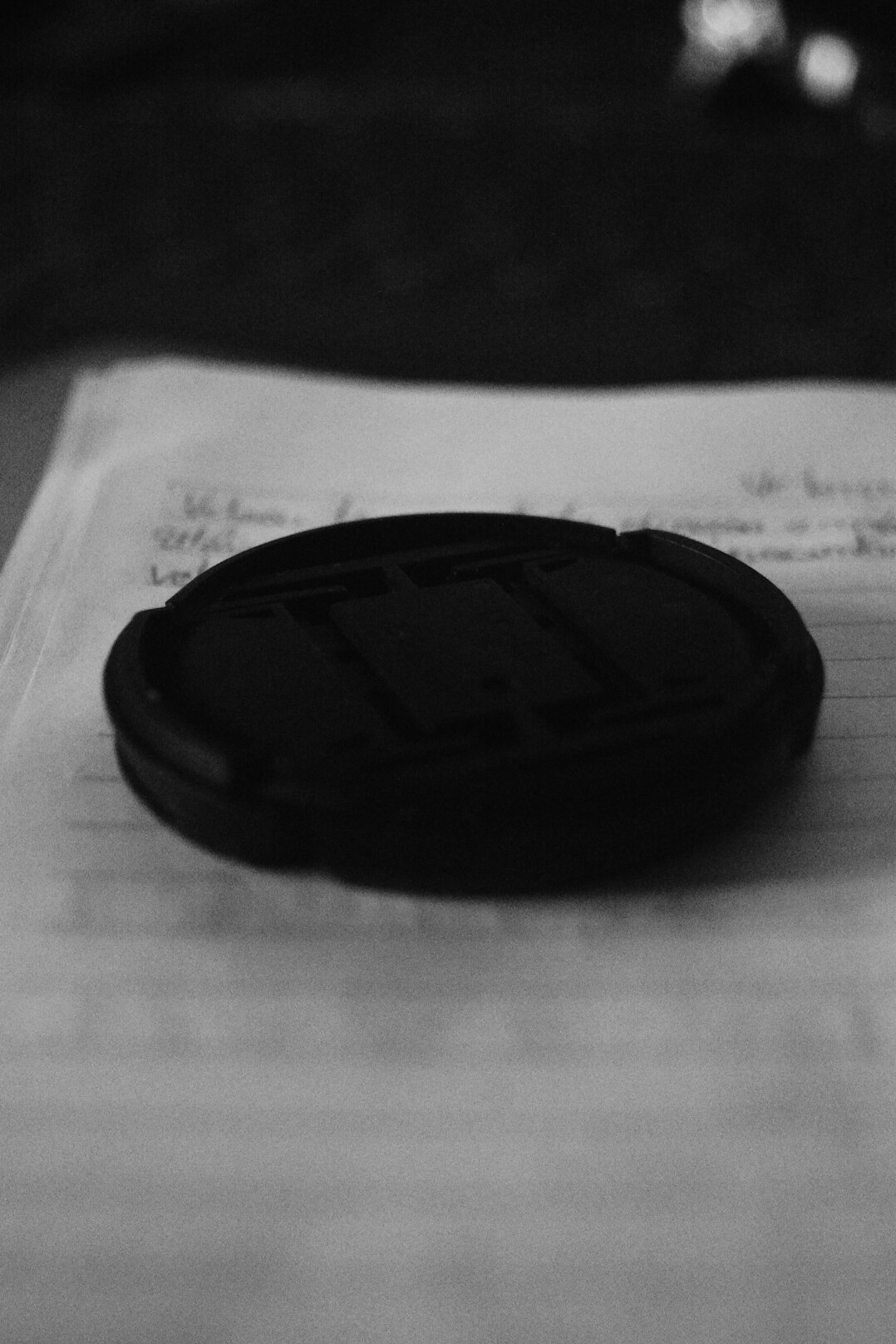 Leather detective notebook with a pen and reading glasses on a desk
